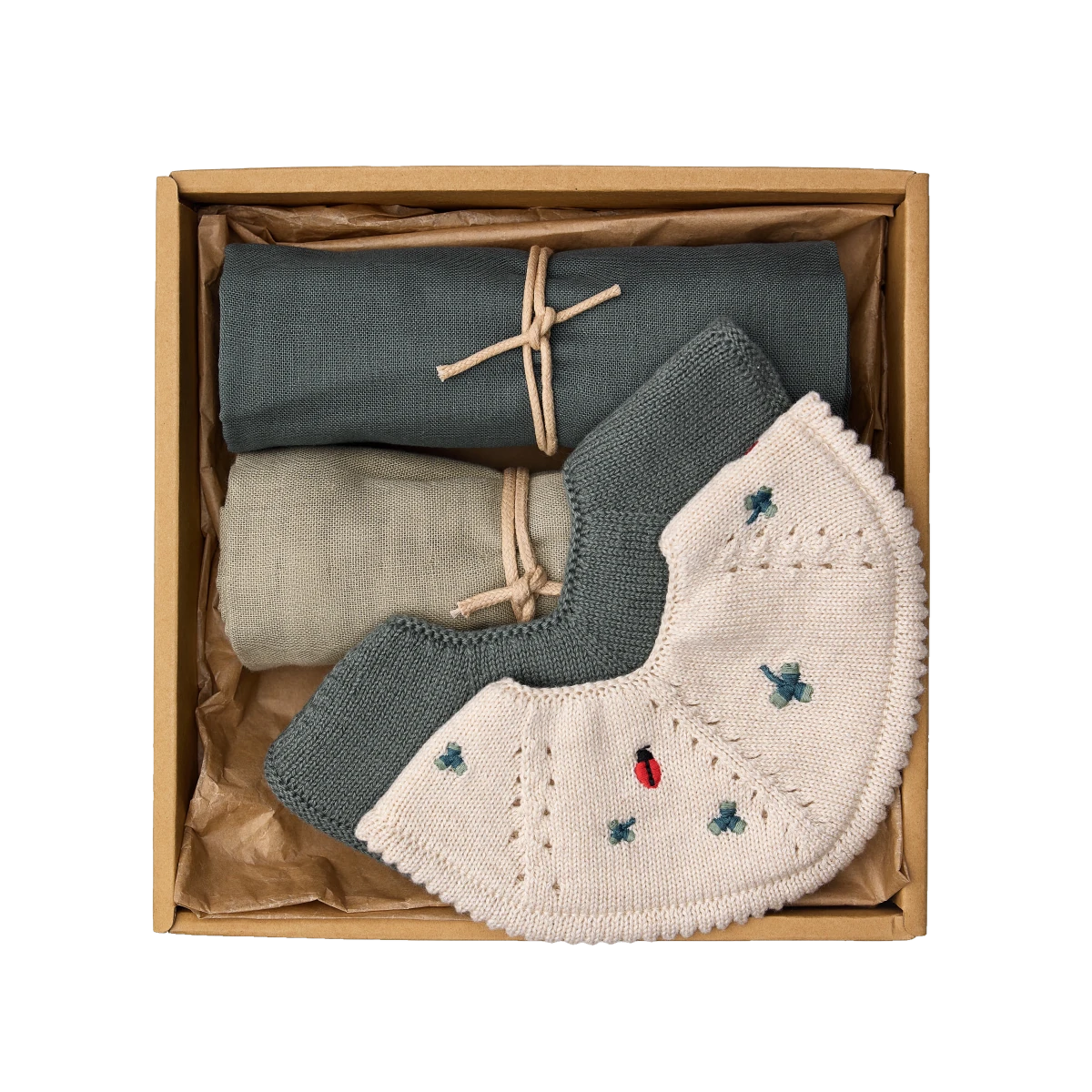 saga copenhagen must-have baby gift box green clover, open box from above with teething bibs and muslin cloths in clover and forest green