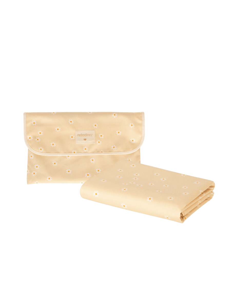 Nobodinoz Waterproof Picnic Blanket Sunshine - Daisies, folded with its strap